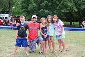 Student counselor poses with kids at Camp Lookout.